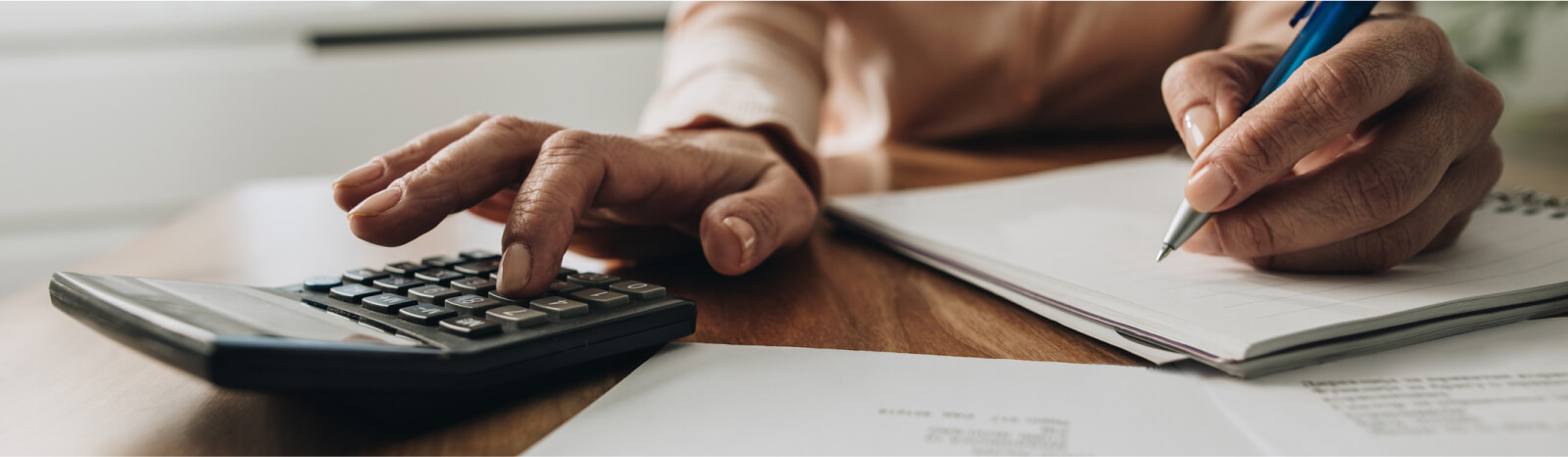 close up of hands using a calculator