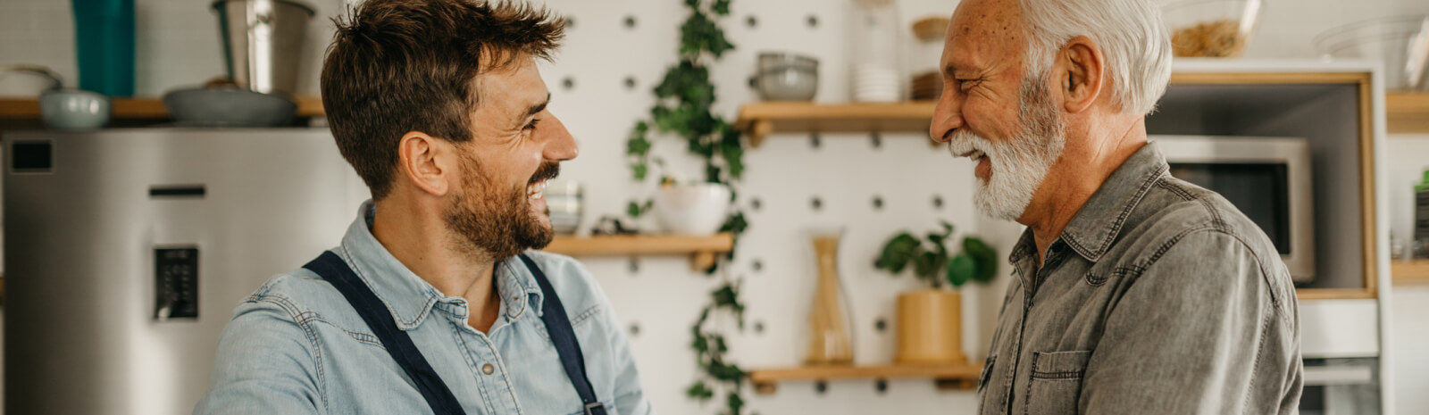 two men talking in a kitchen