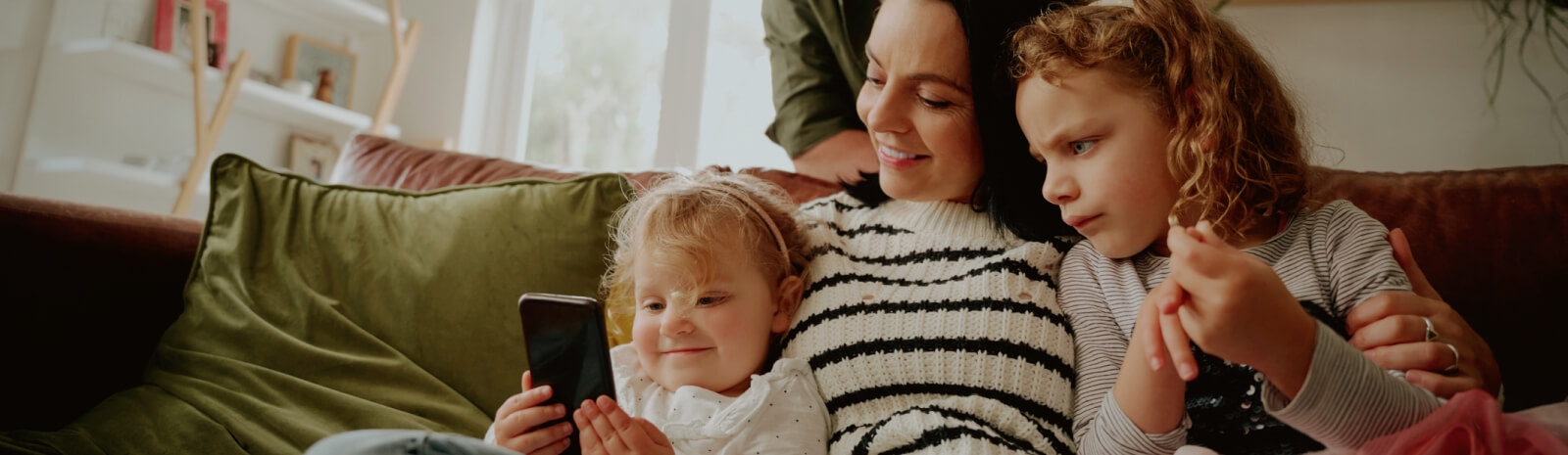 young family looking at a phone